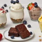 A variety of high protein desserts, including parfaits, brownies, and chia seed pudding, arranged on a table.