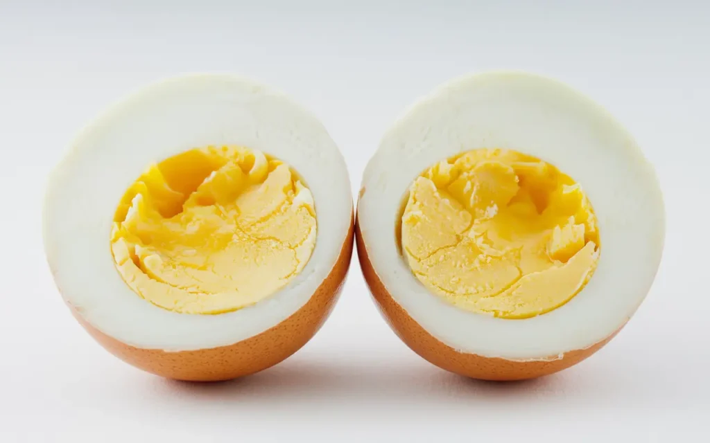 Benefits of Eggs shown with two boiled egg halves on a white background