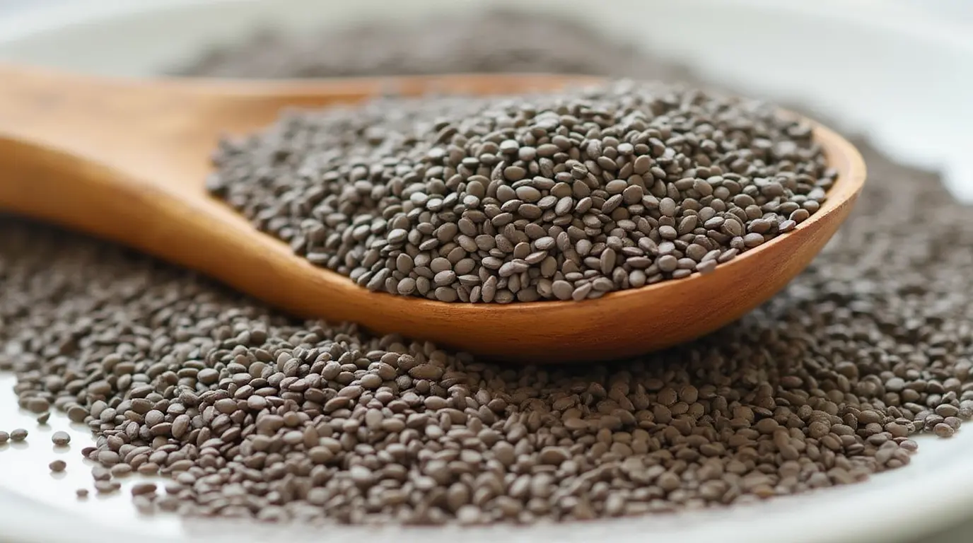 Spoonful of chia seeds on a wooden surface, showing the Benefits of Chia Seeds for fiber, omega 3s, and protein