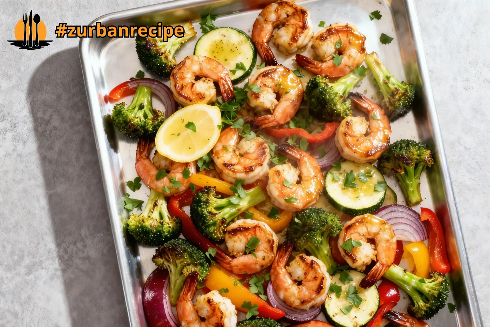 Sheet Pan Shrimp Scampi with roasted broccoli, peppers, and zucchini on a baking tray.