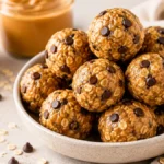 No bake protein bites peanut butter in a bowl with rolled oats, chocolate chips, and creamy peanut butter, easy high protein snack for meal prep and healthy eating