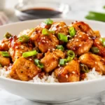 Quick honey garlic chicken served over steamed rice with a glossy honey garlic sauce, tender chicken breast, green onions, and sesame seeds for an easy 20-minute family dinner.